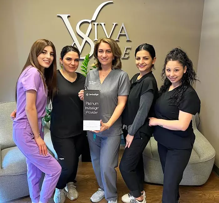 Viva Smile Dental Staff Holding Platinum Invisalign Plaque